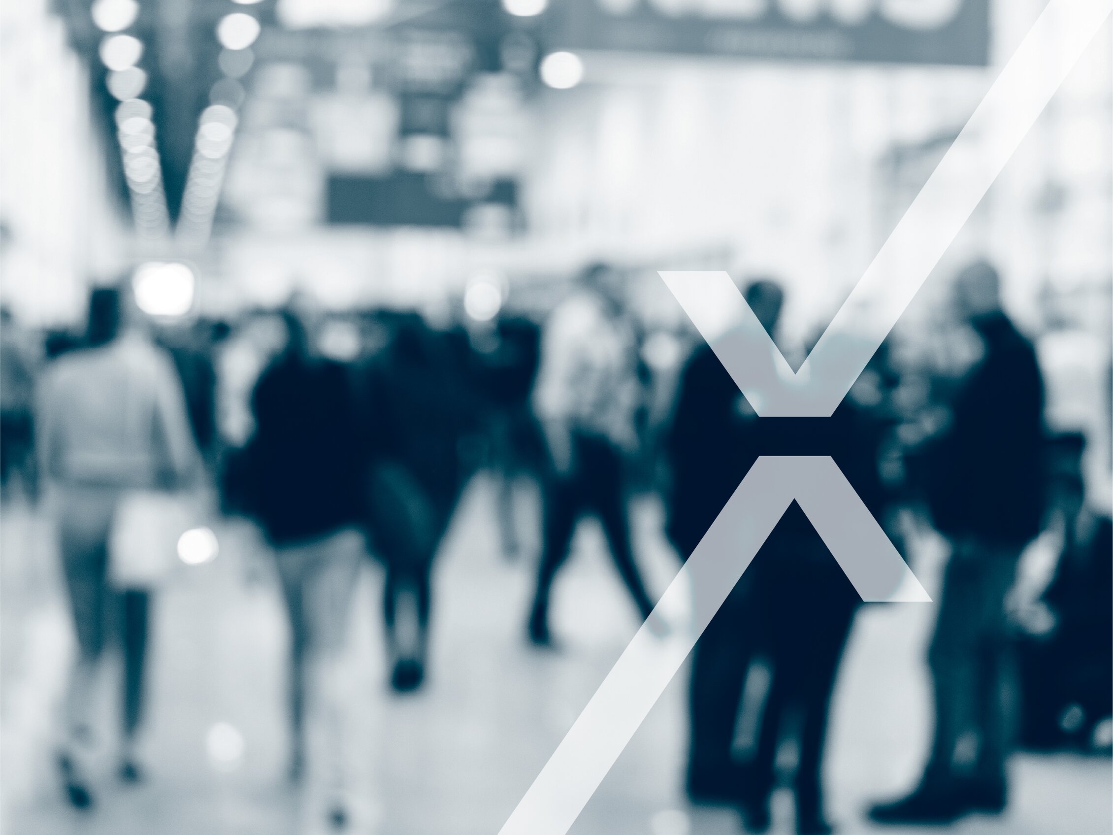 people walking inside a trade fair, with the IEG Deutschland logo in the foreground